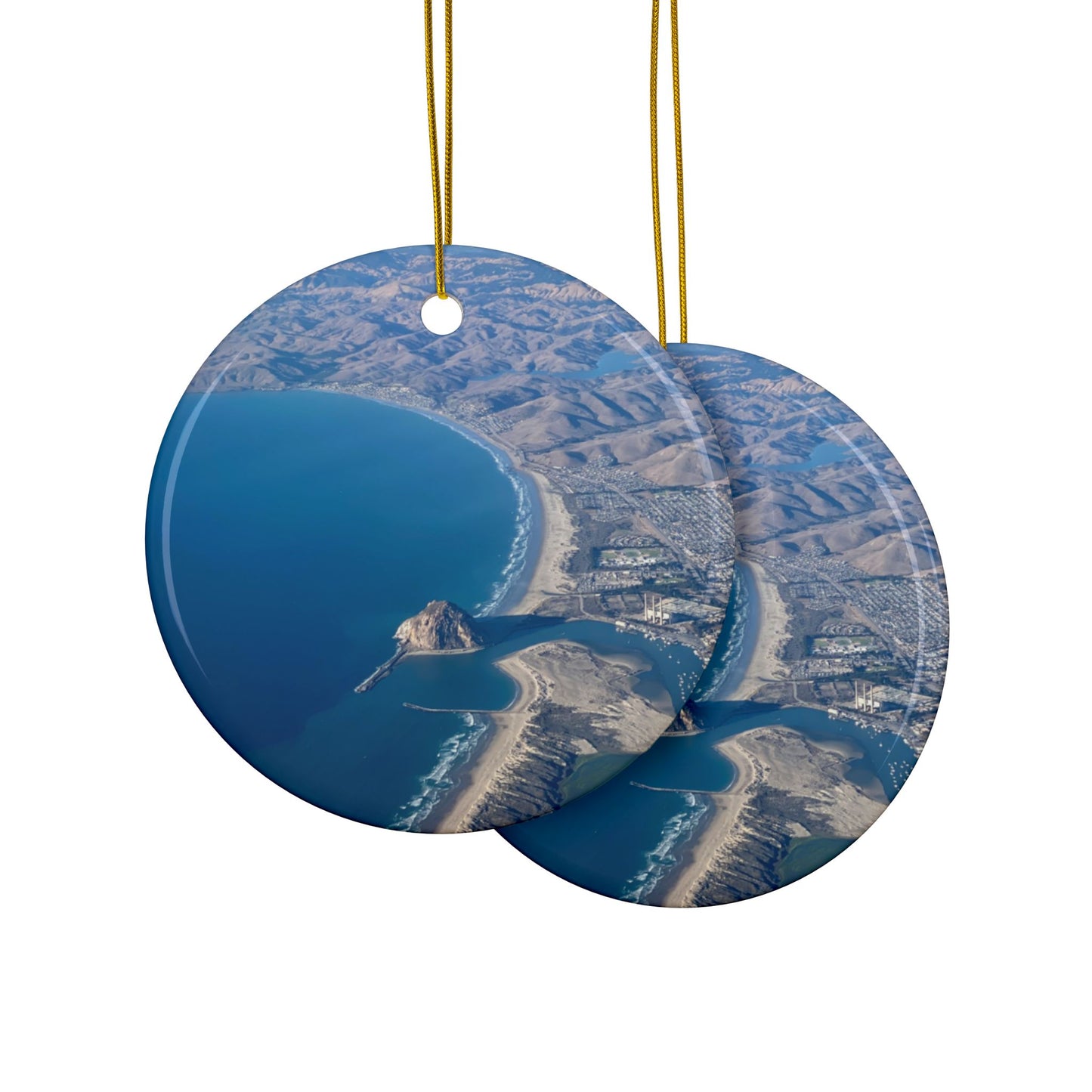 Front and back side of a ceramic holiday ornament featuring an aerial photograph of Morro Rock and the coastline of Morro Bay, California, with vibrant blue water and golden hills