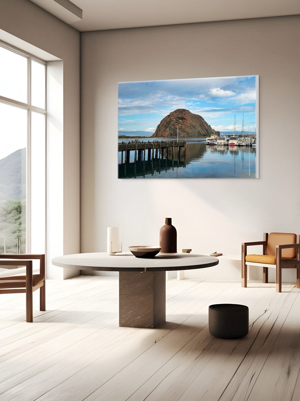 Modern living room with a large A canvas print featuring a view of Morro Rock from the harbor in Morro Bay, California with boats and a pier, surrounded by furniture.