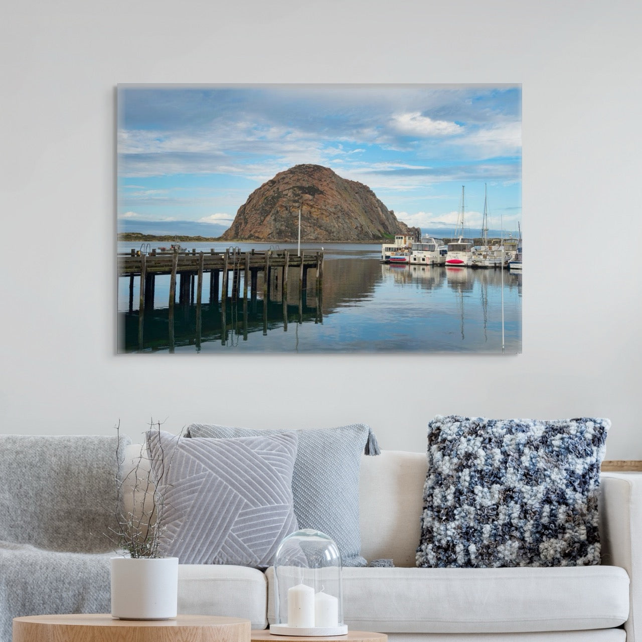 Living room with a large canvas print featuring a view of Morro Rock from the harbor in Morro Bay, California with boats and a pier.