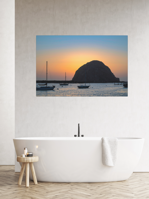 Large wall art of a Morro Rock sunset in a modern bathroom.