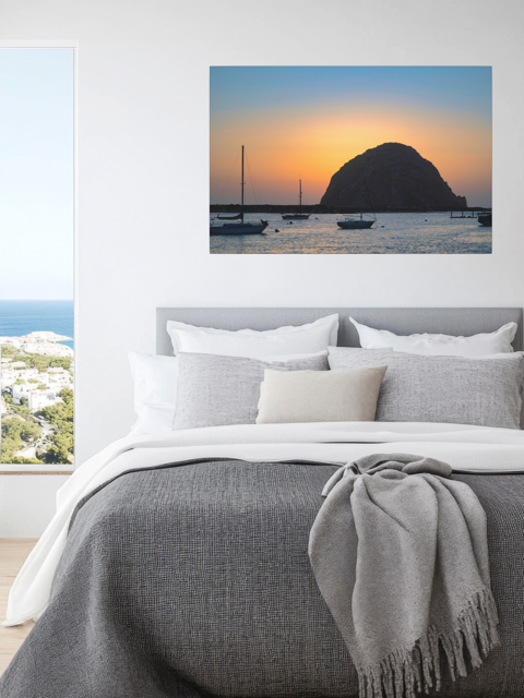 Bedroom with a large wall art of a Morro Rock sunset with sailboats.