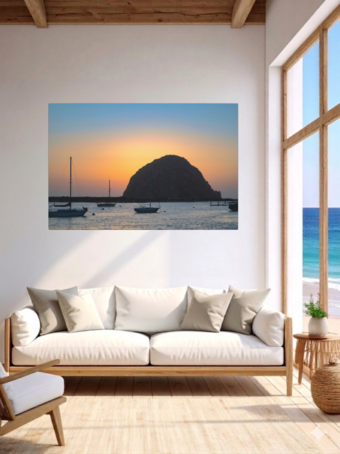 Living room with a large wall art of a sunset over Morro Bay, California.