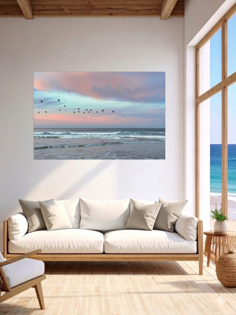 Living room with a largecanvas print of birds flying over pastel pink sunrise in Morro Bay.