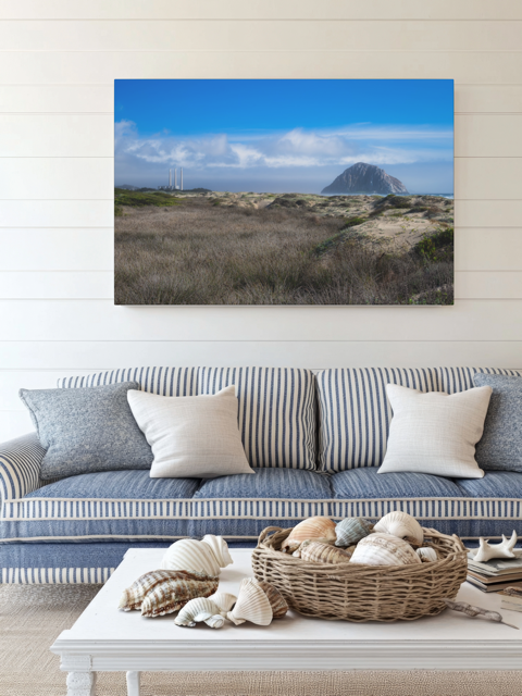 Living room with a couch, coffee table, and a Morro Rock and stacks view from the beach dunes canvas print.