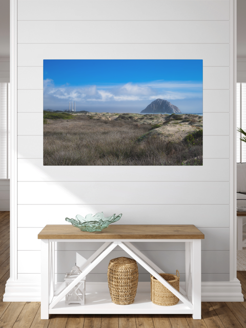 Morro Rock and stacks view from the beach dunes canvas print with a bench and decorative items below.