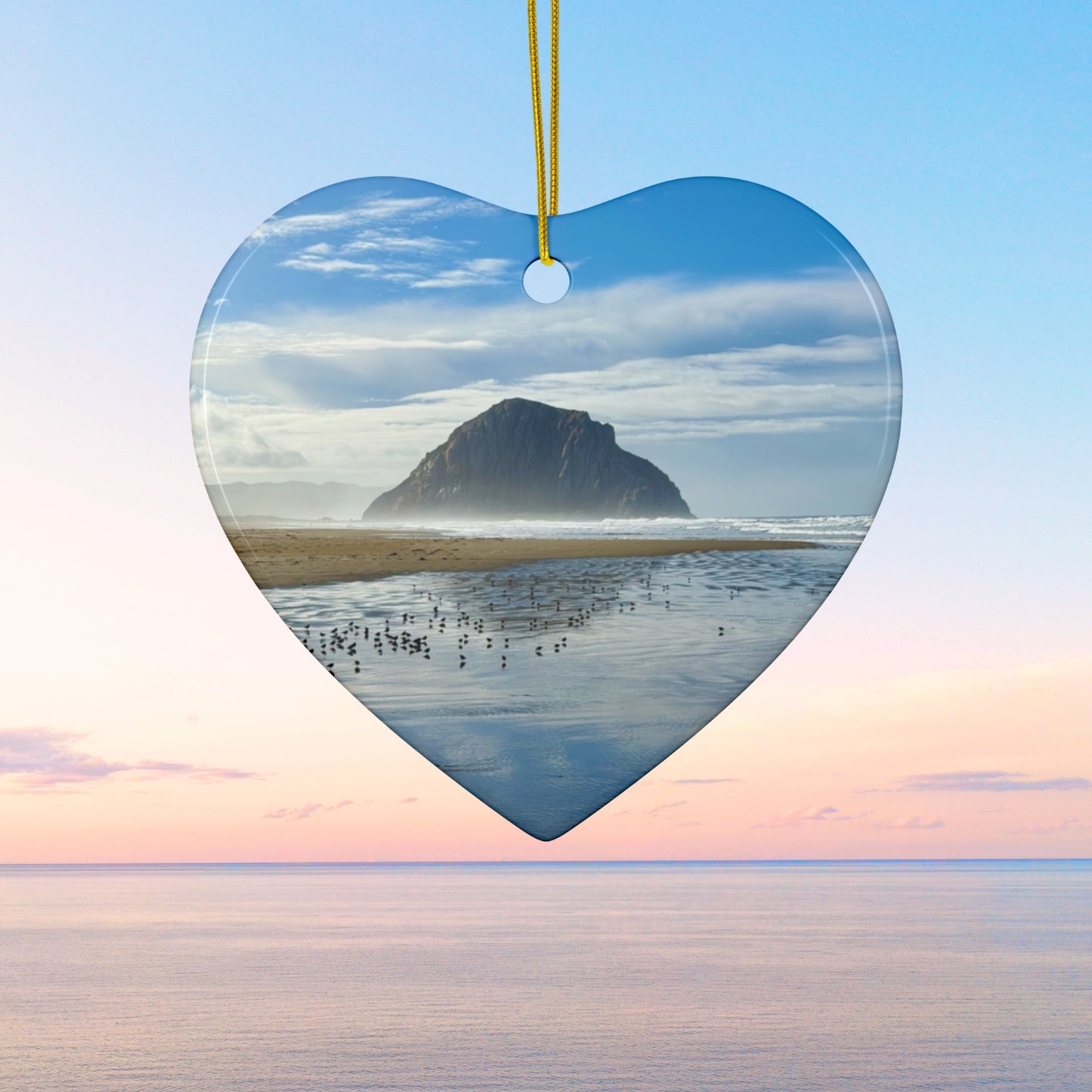 Heart-shaped ceramic holiday ornament featuring a professional photograph of Morro Rock in Morro Bay, California, with the Pacific surf in the foreground.