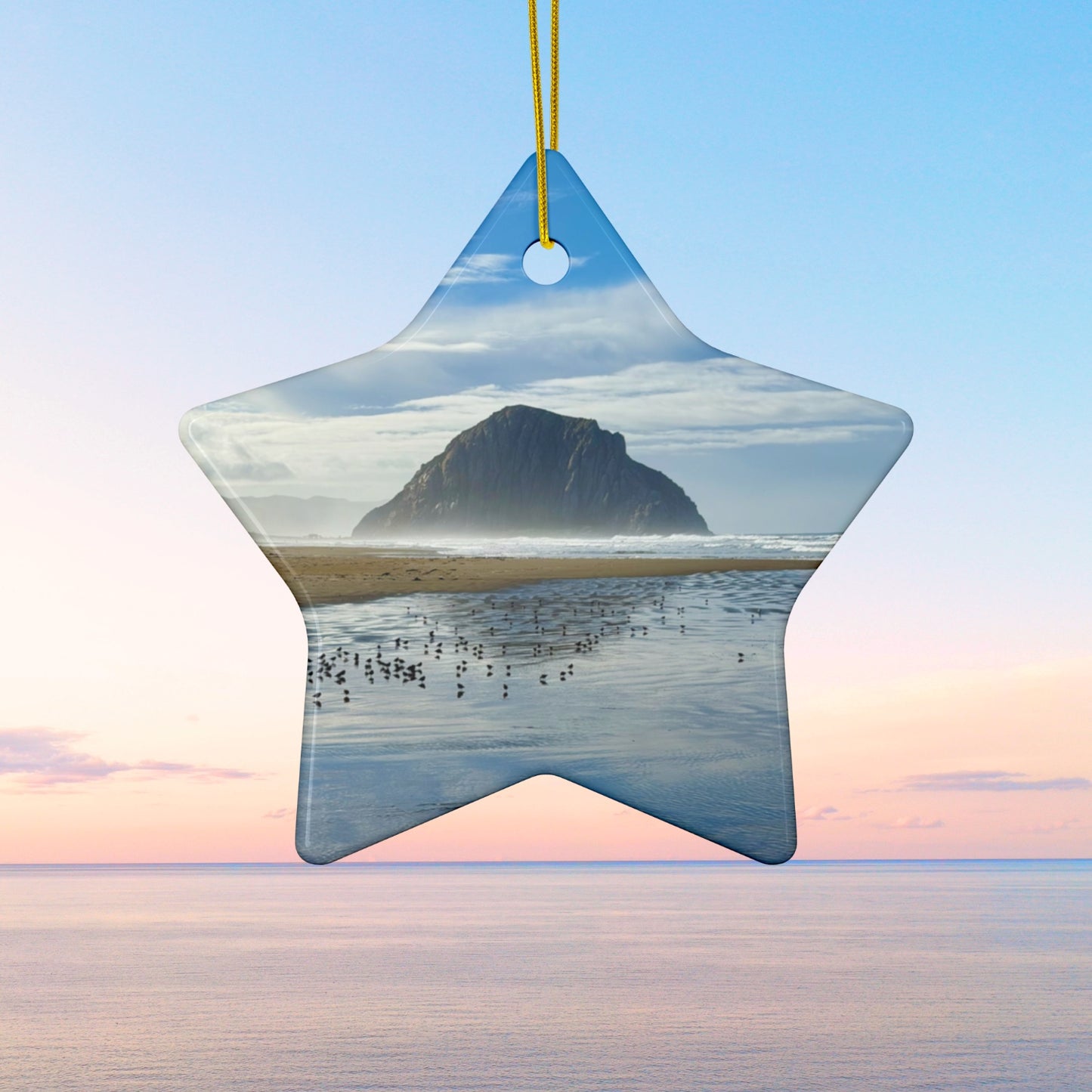 Star-shaped ceramic holiday ornament featuring a professional photograph of Morro Rock in Morro Bay, California, with the Pacific surf in the foreground.