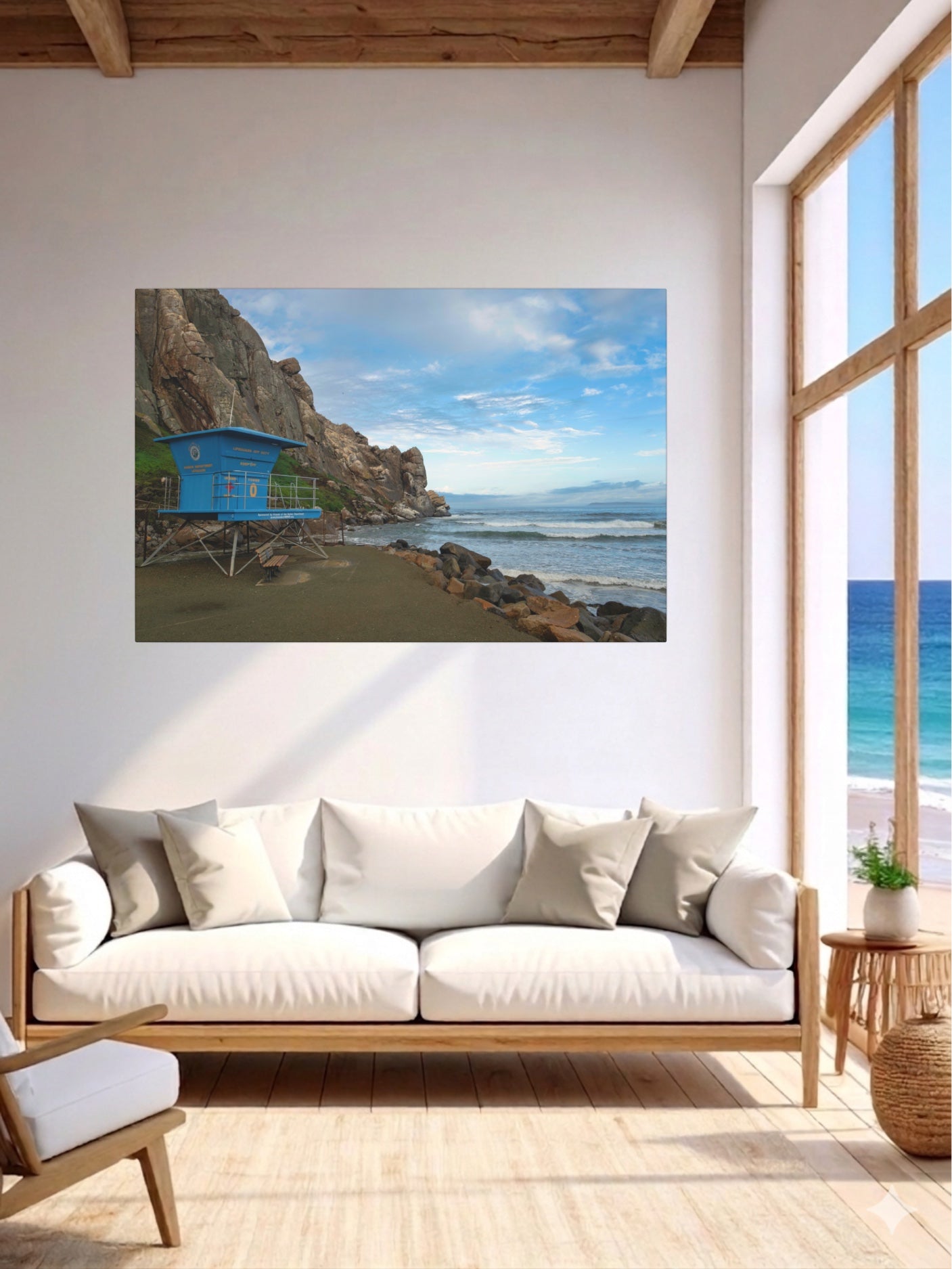 Living room with a large window and a blue lifeguard tower at the base of Morro Rock in Morro Bay California canvas print.