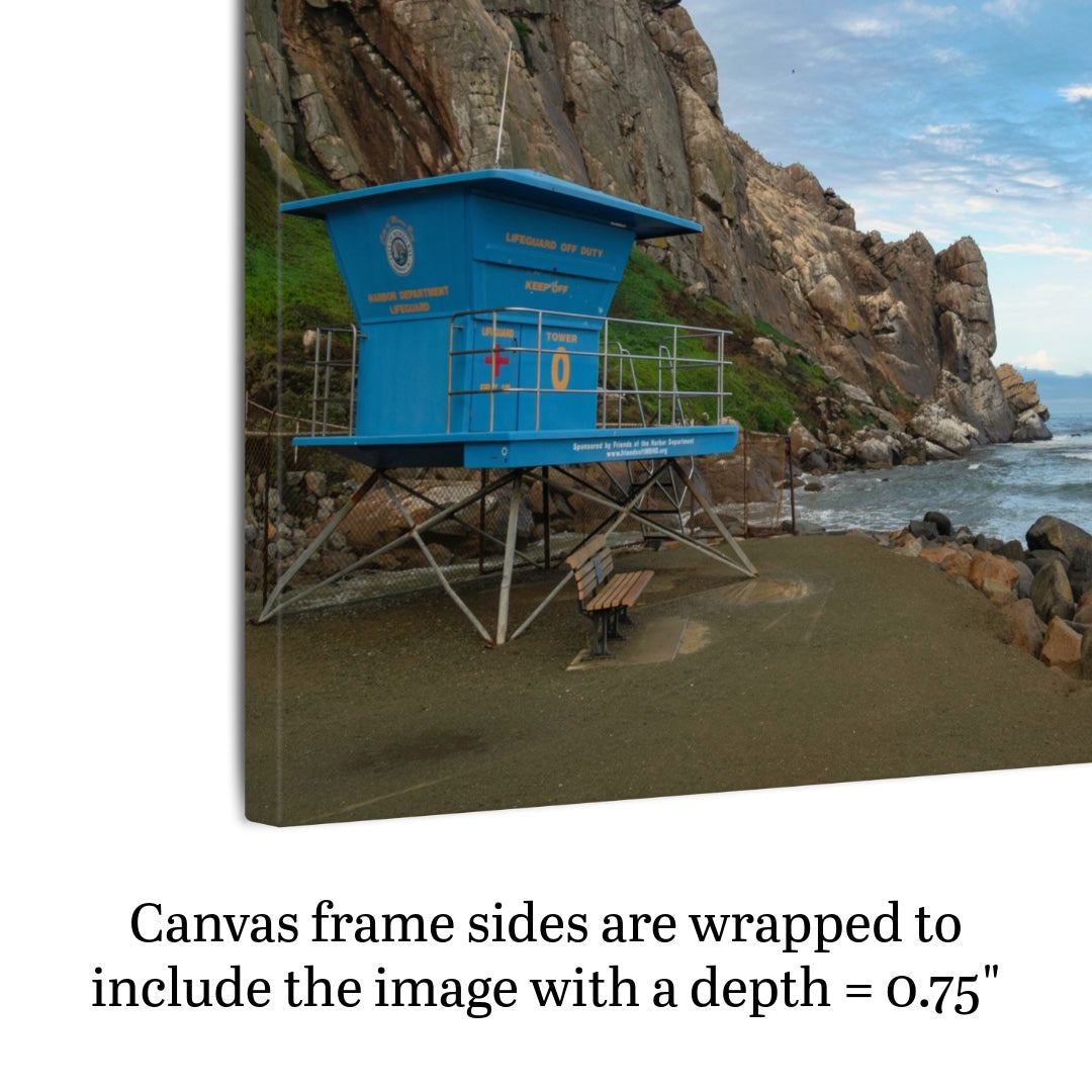 Side View of a blue lifeguard tower at the base of Morro Rock in Morro Bay California canvas print with text indicating frame depth.