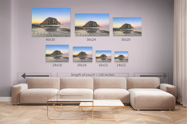Canvas prints featuring a Morro Rock morning reflection in wet beach sand in various sizes displayed on a wall above a sofa.