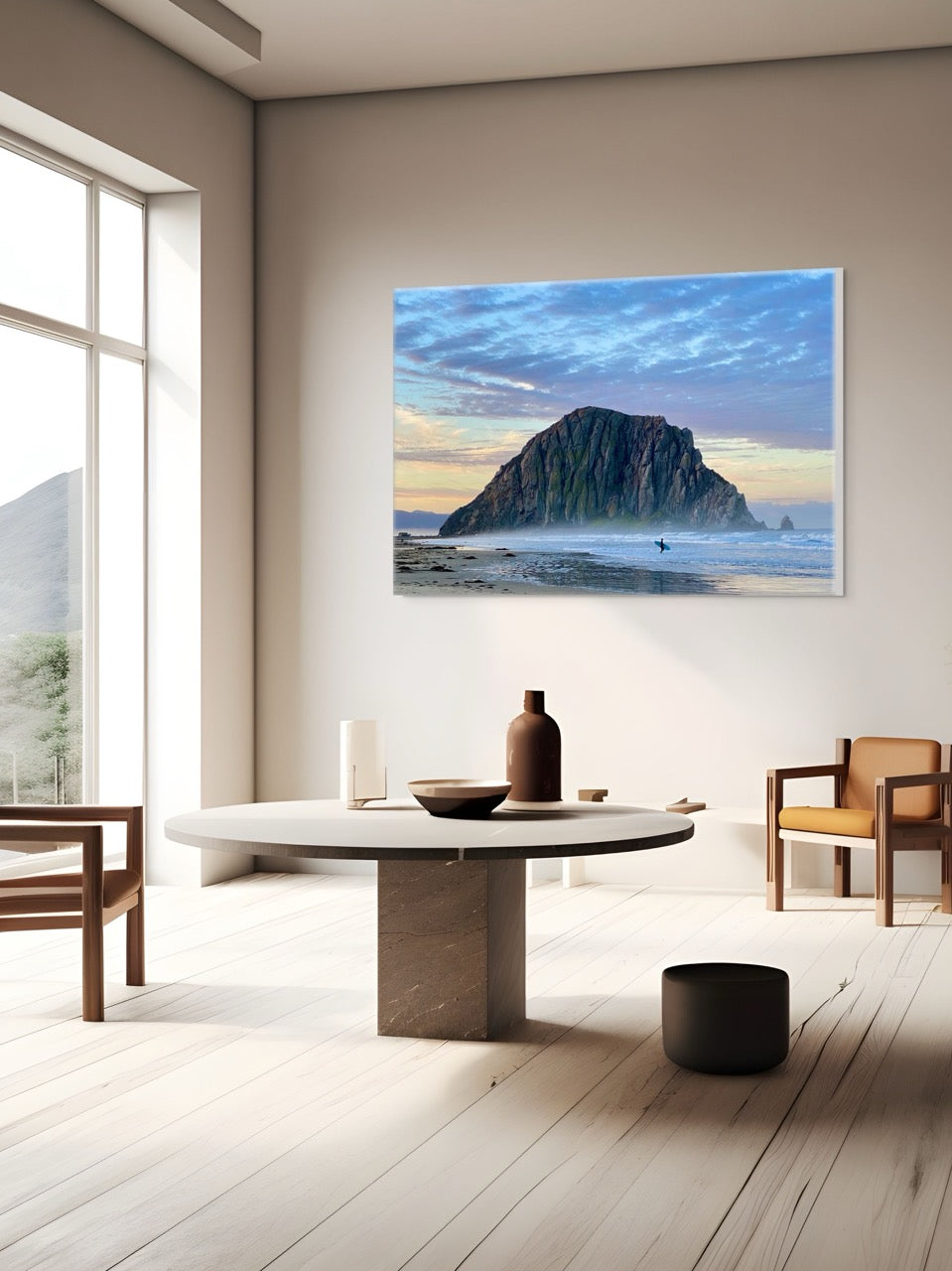 Large canvas print of a sunrise at Morro Rock in Morro Bay, California with a surfer on the beach in a modern living room.