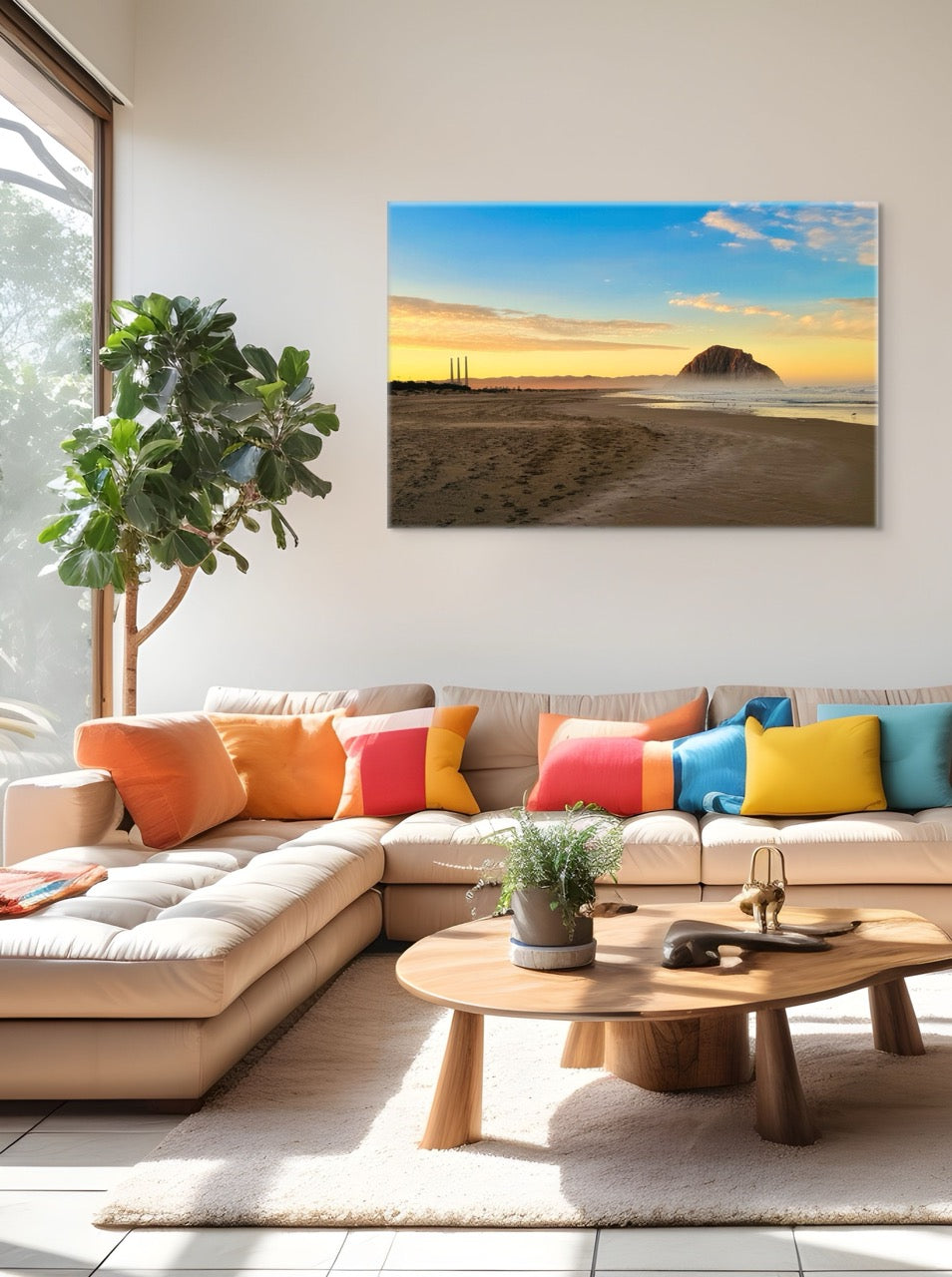 Modern living room with a sectional sofa, colorful pillows, and a canvas print of Morro Rock and the stack at sunrise on the wall.