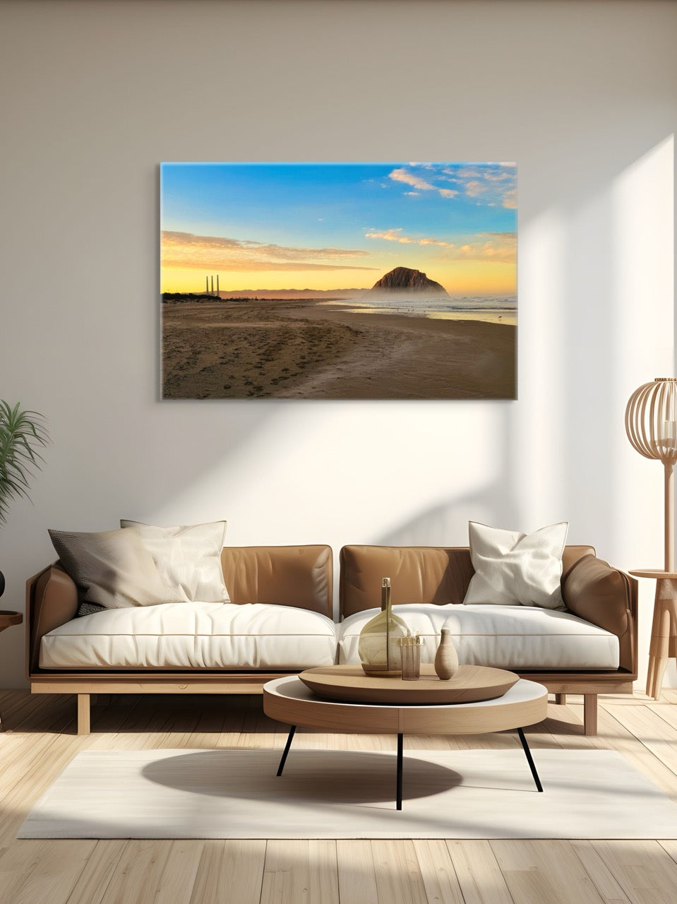 Modern living room with a couch, coffee table, and canvas print of Morro Rock and the stack at sunrise.
