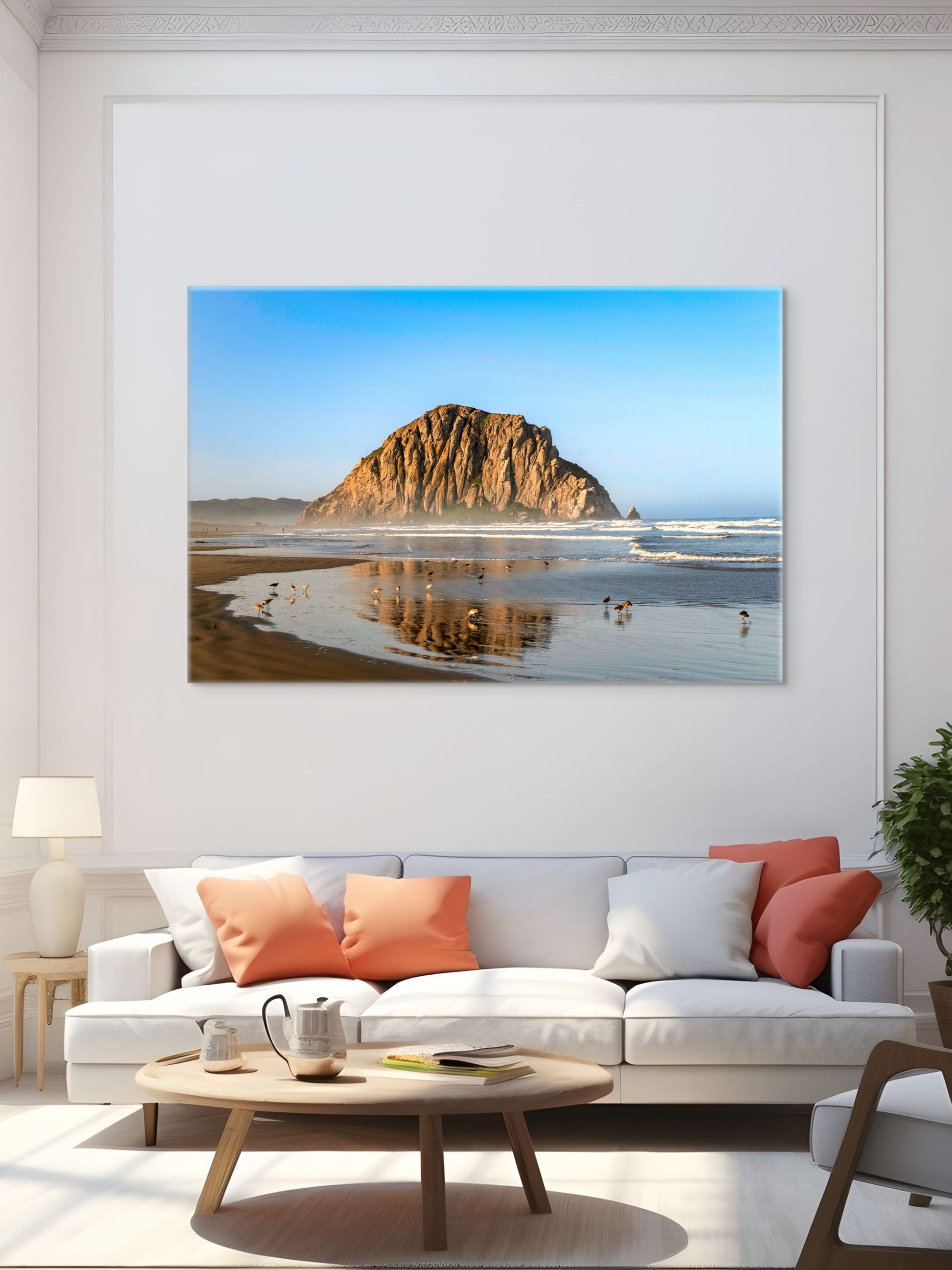 Living room with a large canvas print of Morro Rock reflecting in the wet sand with birds on the shoreline on the wall.