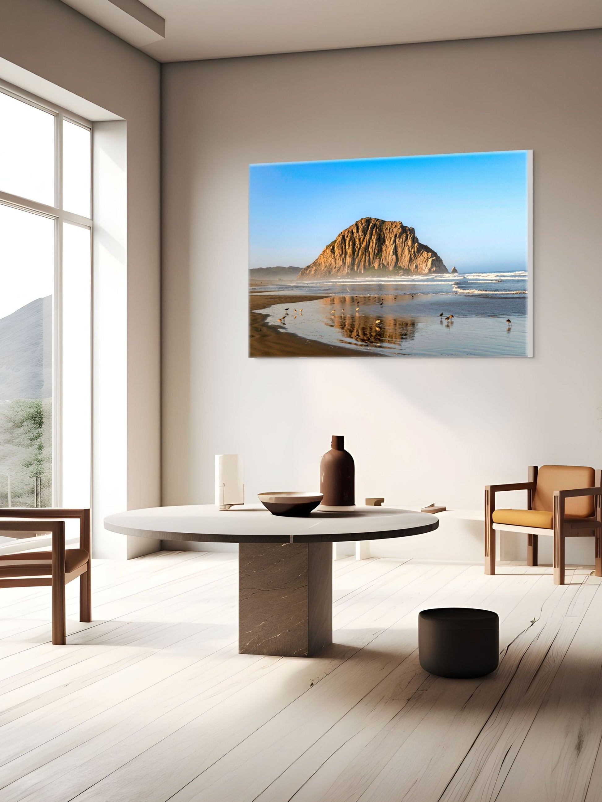 Modern interior with a canvas print of Morro Rock reflecting in the wet sand with birds on the shoreline on the wall