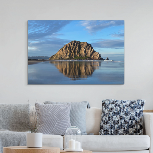 Living room with a large canvas print of Morro Rock reflecting in the wet sand with clouds.