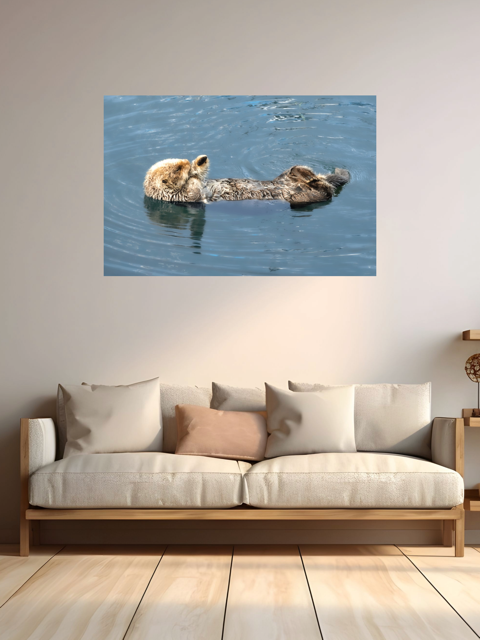 Canvas print of an otter in water above a beige sofa with pillows.