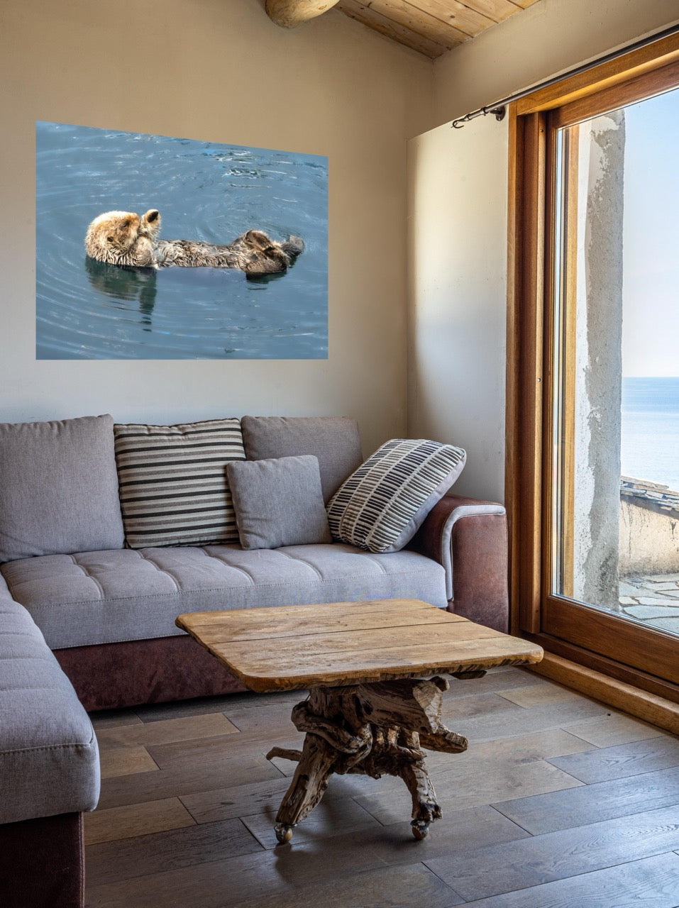 Living room with a sofa, coffee table, and wall art of a sea otter.