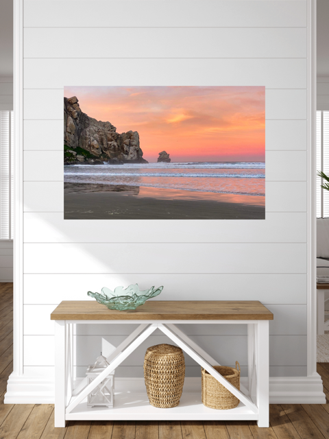 Beach scene painting on a white wall above a wooden bench with storage.