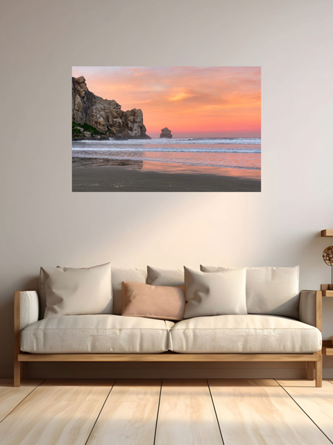 Beach scene with sunset on a wall above a sofa
