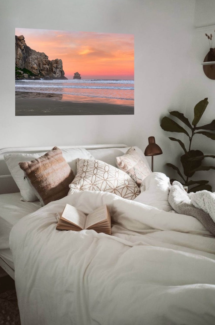 Bedroom with a sunrise sky over the ocean canvas print on the wall