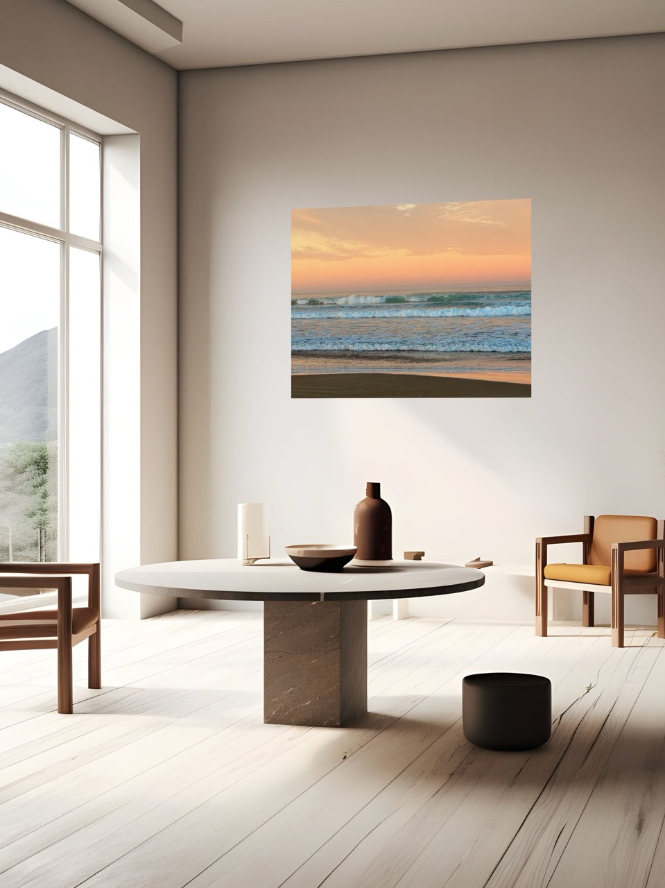 Modern living room with a round marble table, chairs, and a large canvas print of a sunrise sky over ocean waves.