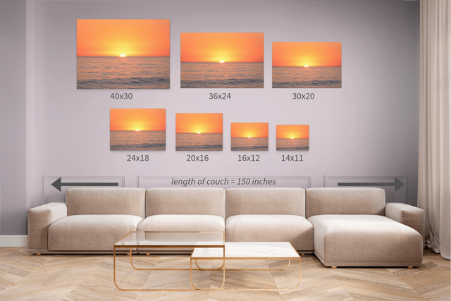 Sizing guide showing the same canvas print of a sunset over the ocean in various sizes on the wall over a beige sofa.
