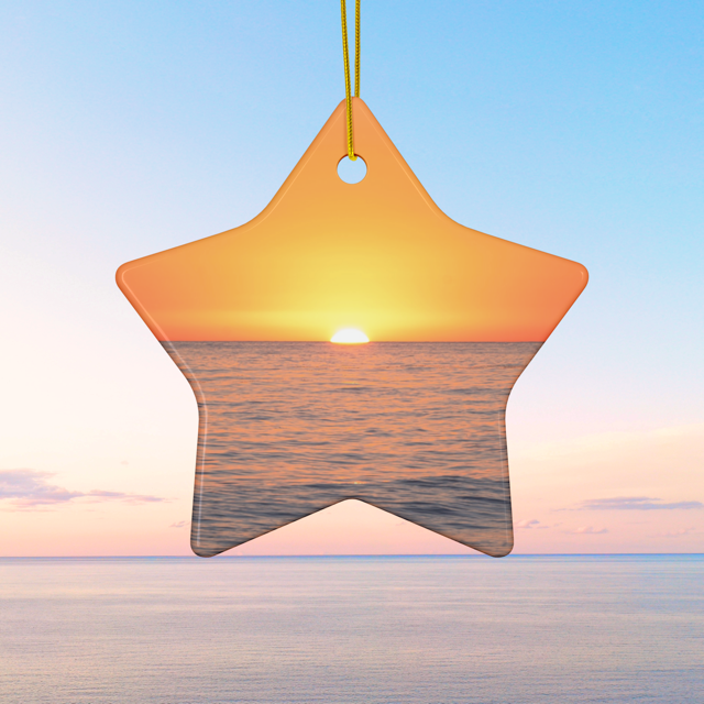 Star-shaped ceramic Christmas ornament featuring a minimalist photograph of a vibrant orange and amber sunset sky over a calm Pacific Ocean