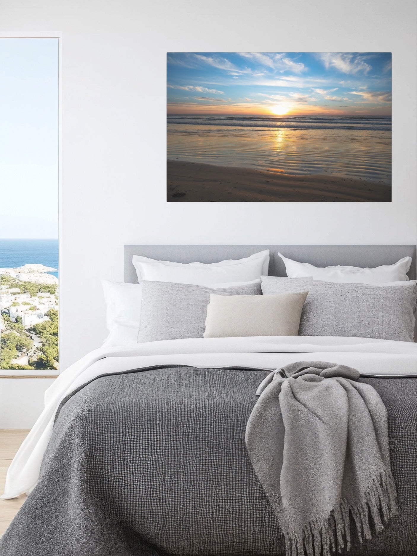 Bedroom with a large wall art of a beach sunset above the bed.