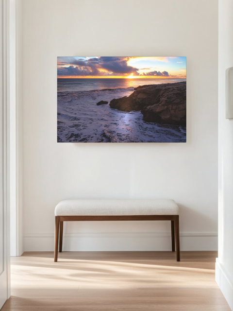 California coastal sunset after rain storm canvas print in a room with a bench.