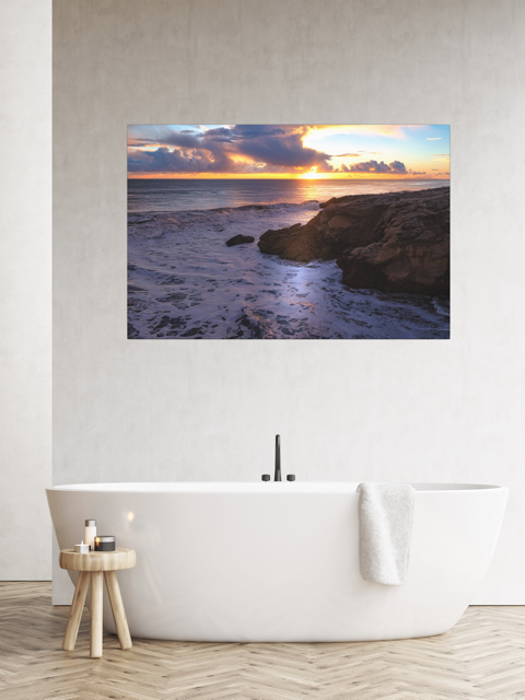 Bathroom with a large wall-mounted artwork depicting a sunset over the ocean.