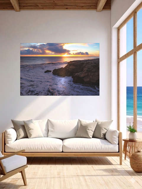 Living room with a California coastal sunset after rain storm canvas print, white sofa, and wooden floor.