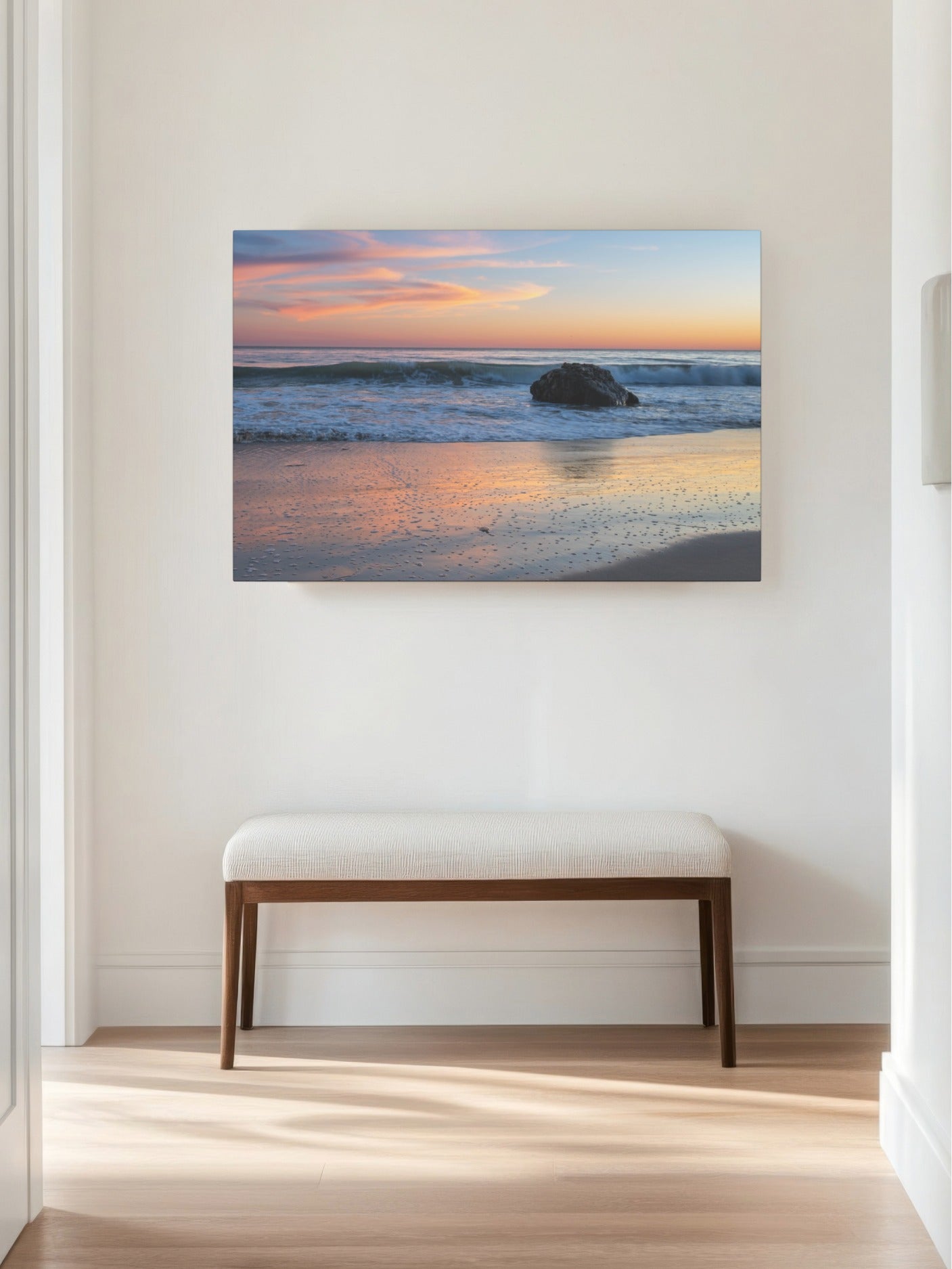 Pastel beach twilight canvas print with pink clouds reflecting on wet sand on a wall above a wooden bench