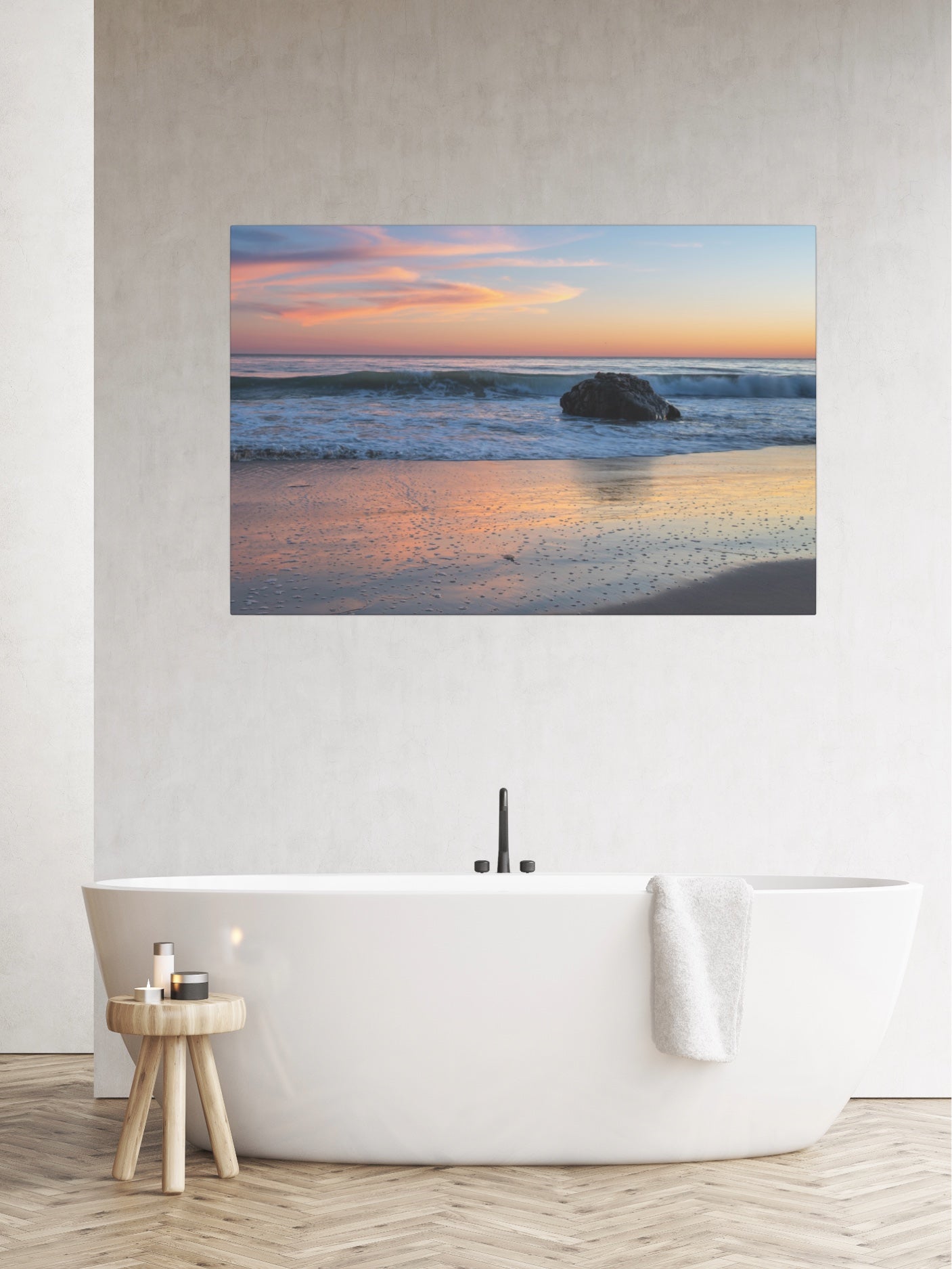Pastel beach twilight canvas print with pink clouds reflecting on wet sand above a white bathtub in a bathroom