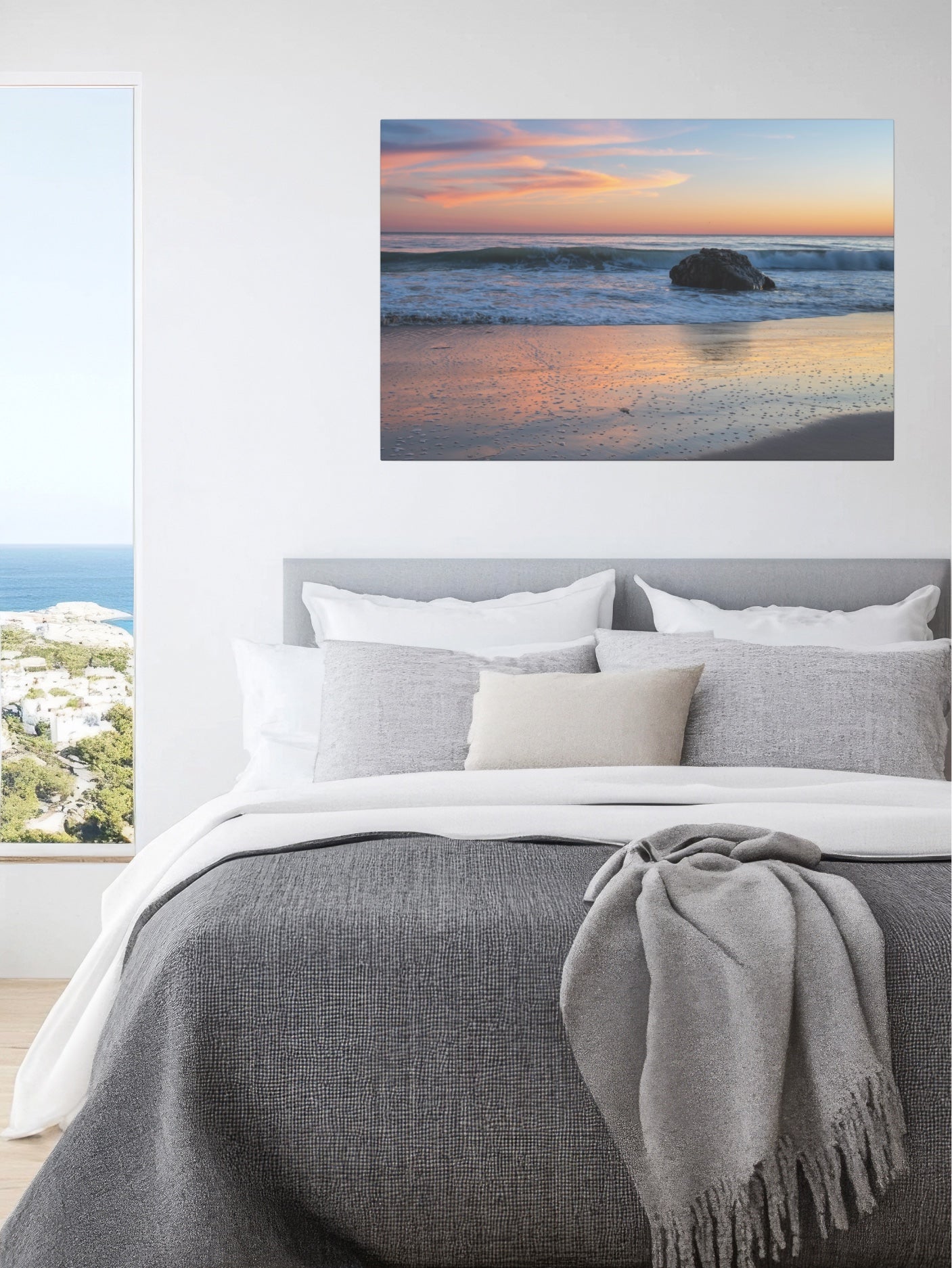 Bedroom with a pastel beach twilight canvas print with pink clouds reflecting on wet sand above the bed.