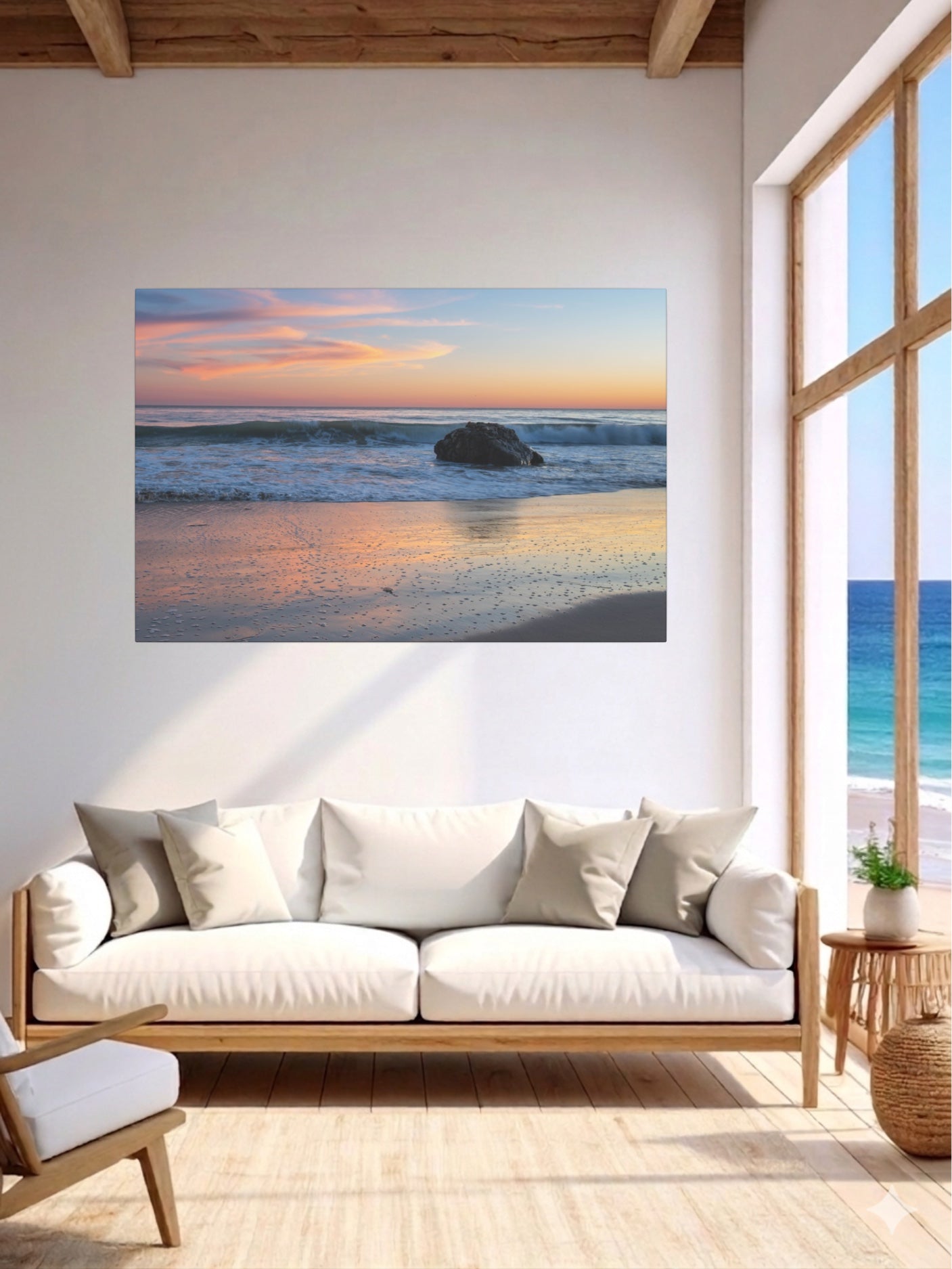 Living room with a pastel beach twilight canvas print with pink clouds reflecting on wet sand on the wall, white sofa, and wooden floor.