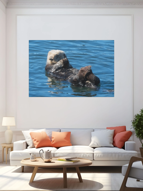 Living room with a large wall art of a sea otter in water above a white sofa with colorful cushions.