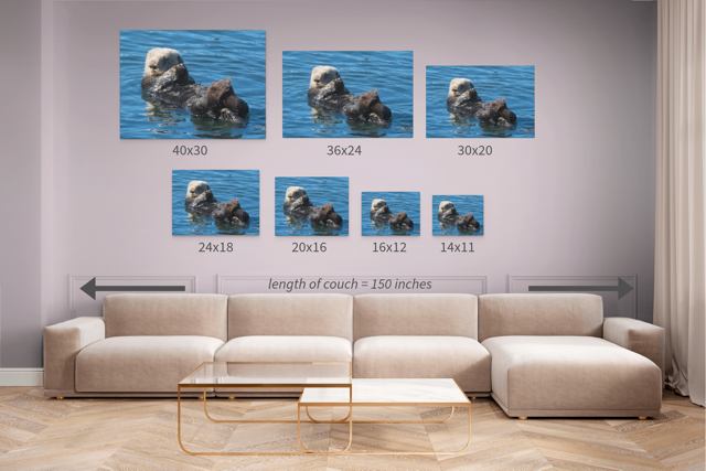 Wall art prints of otters in a living room setting with size chart