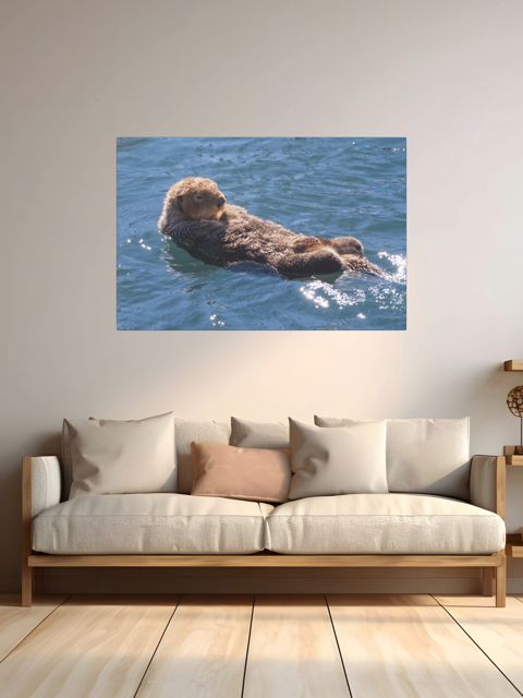 Canvas print of an otter in water on a wall above a sofa