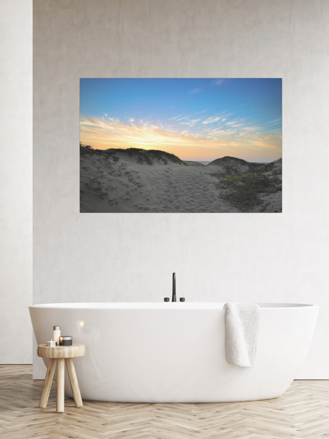 Bathroom with a canvas print of a beach sunset over the sand dunes.