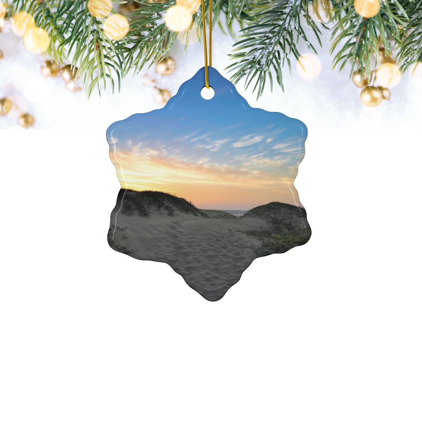 Ceramic holiday ornament featuring a landscape photograph of a California beach at sunset with rolling sand dunes, footprints, and gold-streaked clouds.
