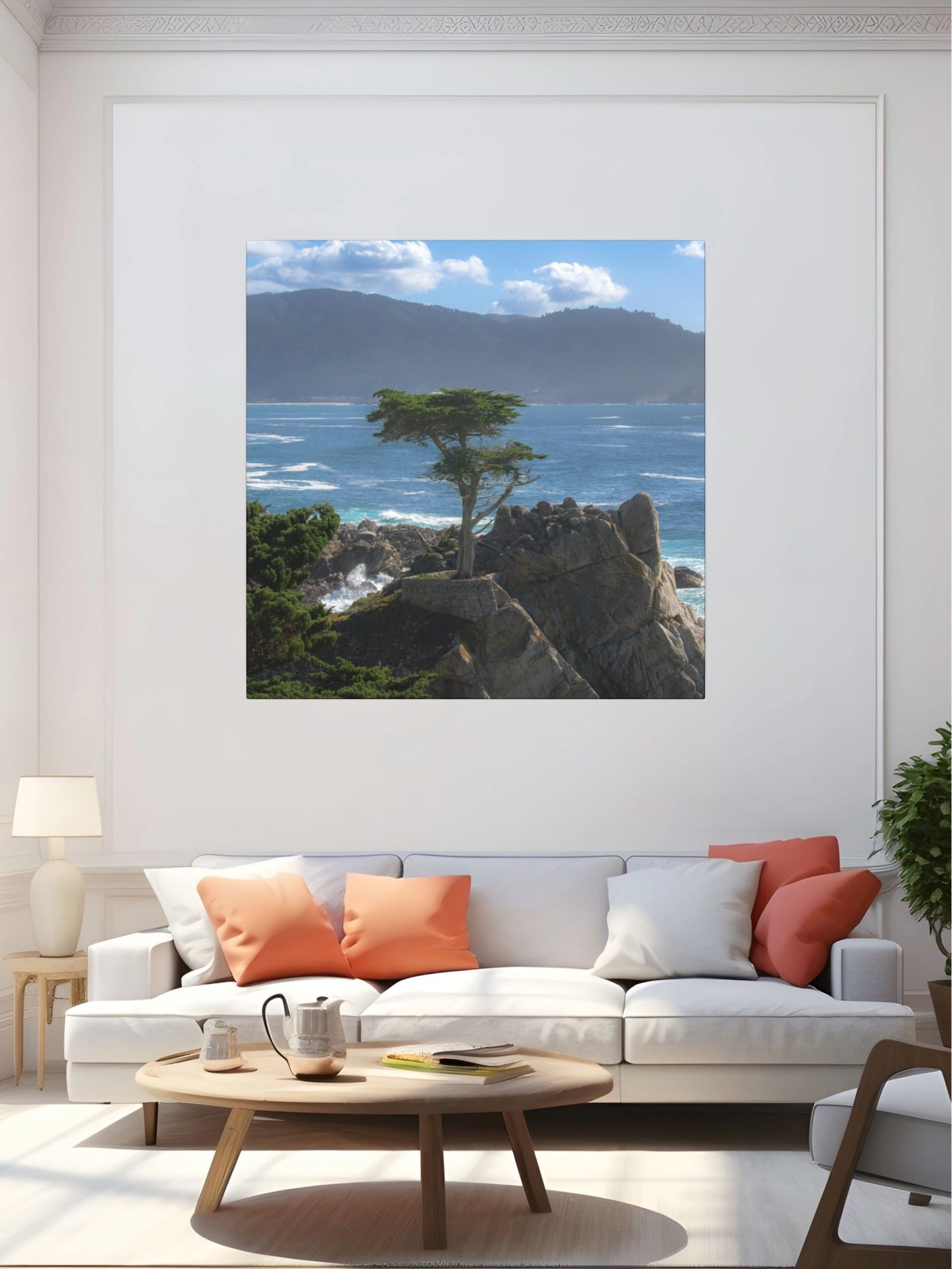 Living room with a white sofa, wooden coffee table, and a canvas print of the lone cypress tree at Pebble Beach on a rocky cliff on the wall.
