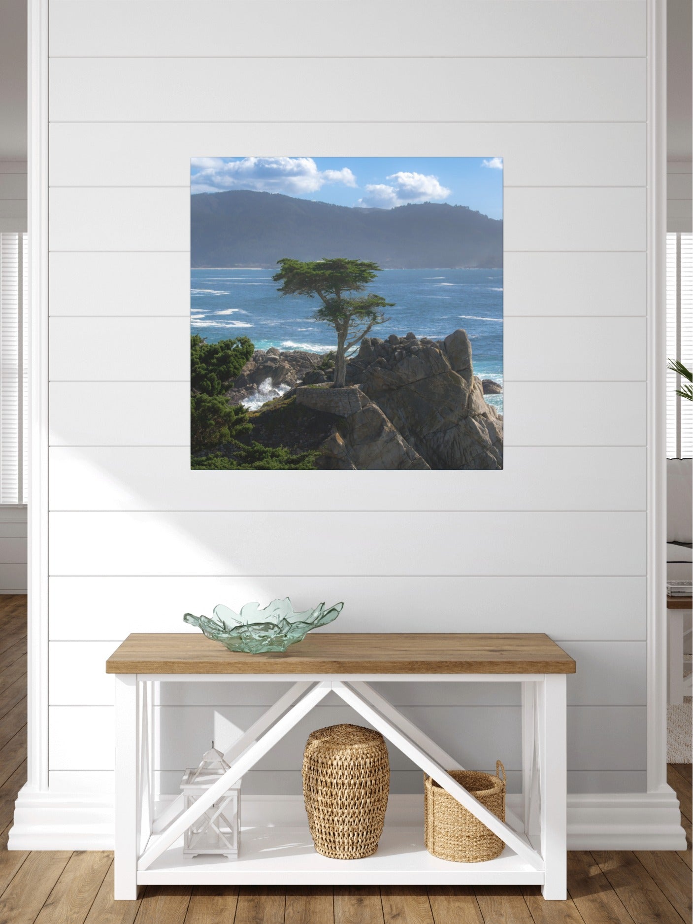 Canvas print of the lone cypress tree at Pebble Beach on a rocky cliff, displayed above a wooden bench.
