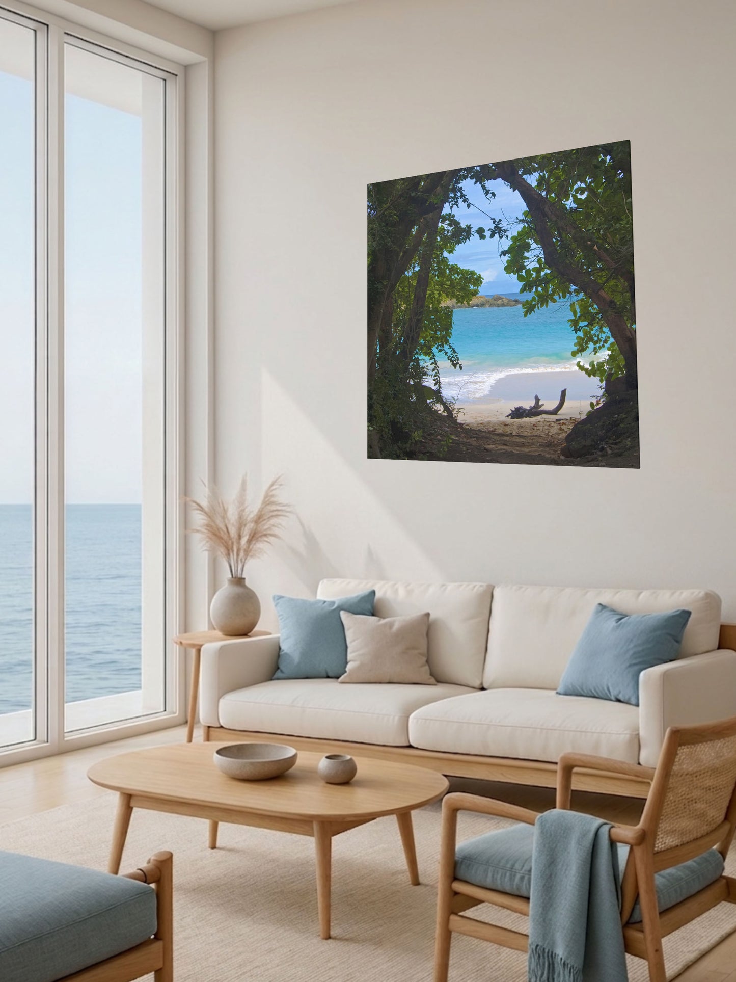 Living room with a large window view of the ocean, a beige sofa with blue cushions, and a tropical beach view through trees Hawaiian island canvas print.