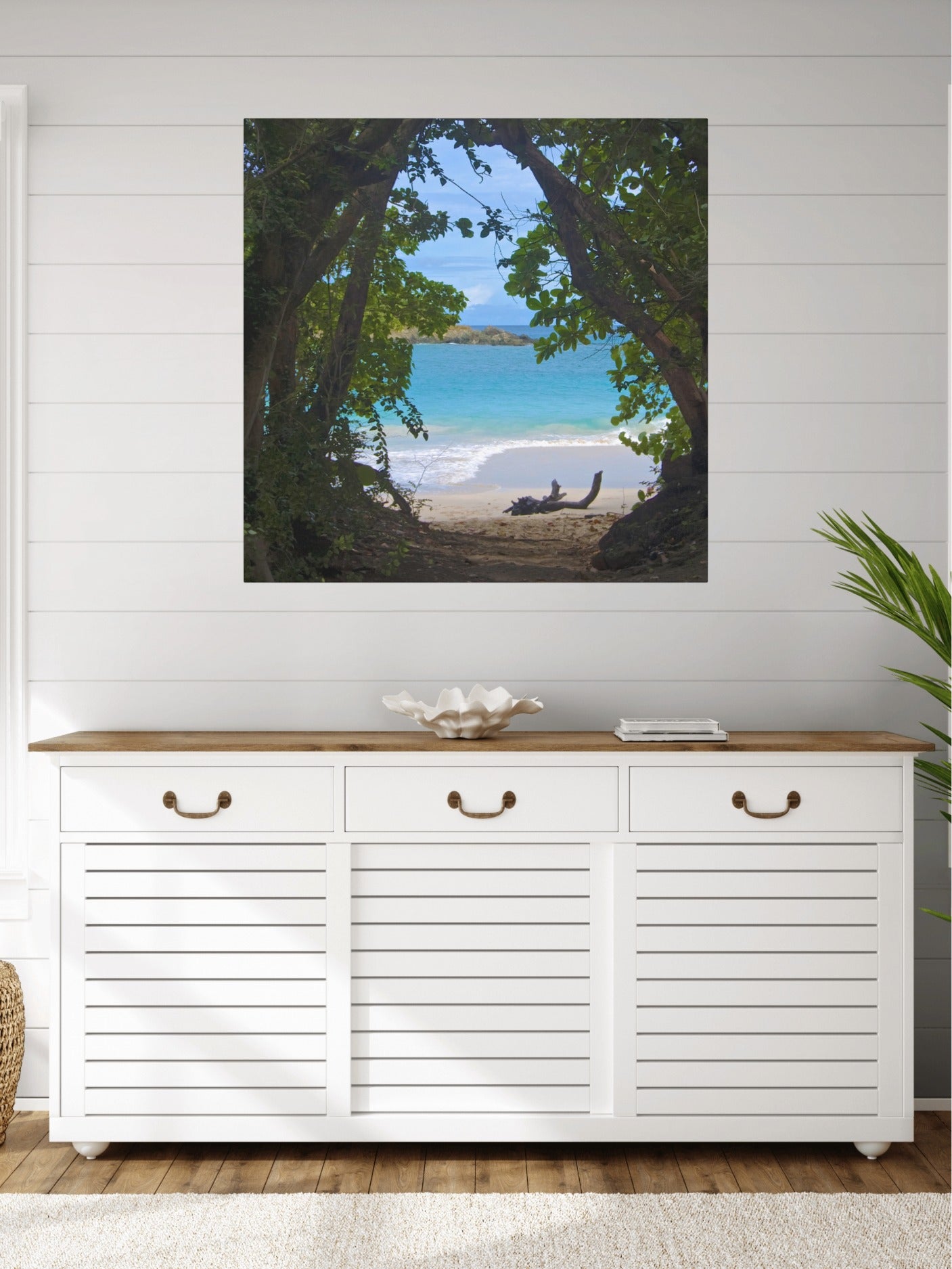 White cabinet with wooden top against a wall with a tropical beach view through trees Hawaiian island canvas print