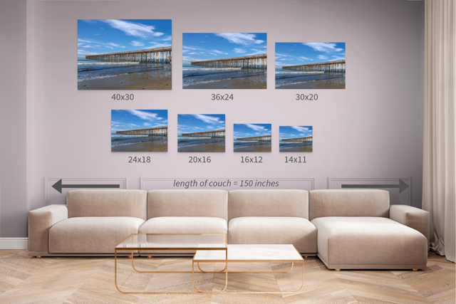 Wall art prints featuring Ventura Pier with corresponding dimensions displayed above a beige sofa.