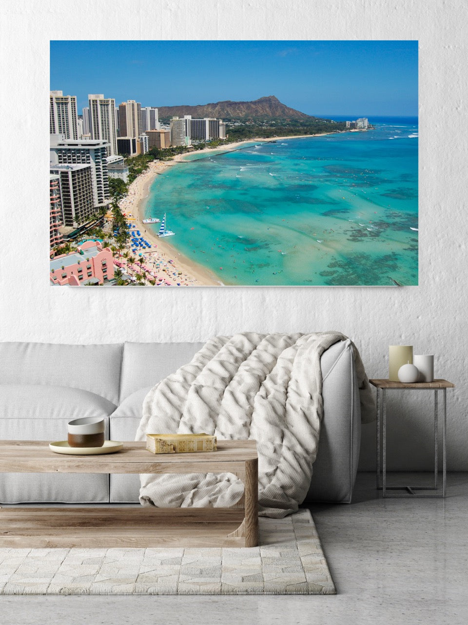 Living room with a large canvas print of an overhead view of the beach and hotels on Waikiki Beach in Hawaii with Diamond Head in the background.