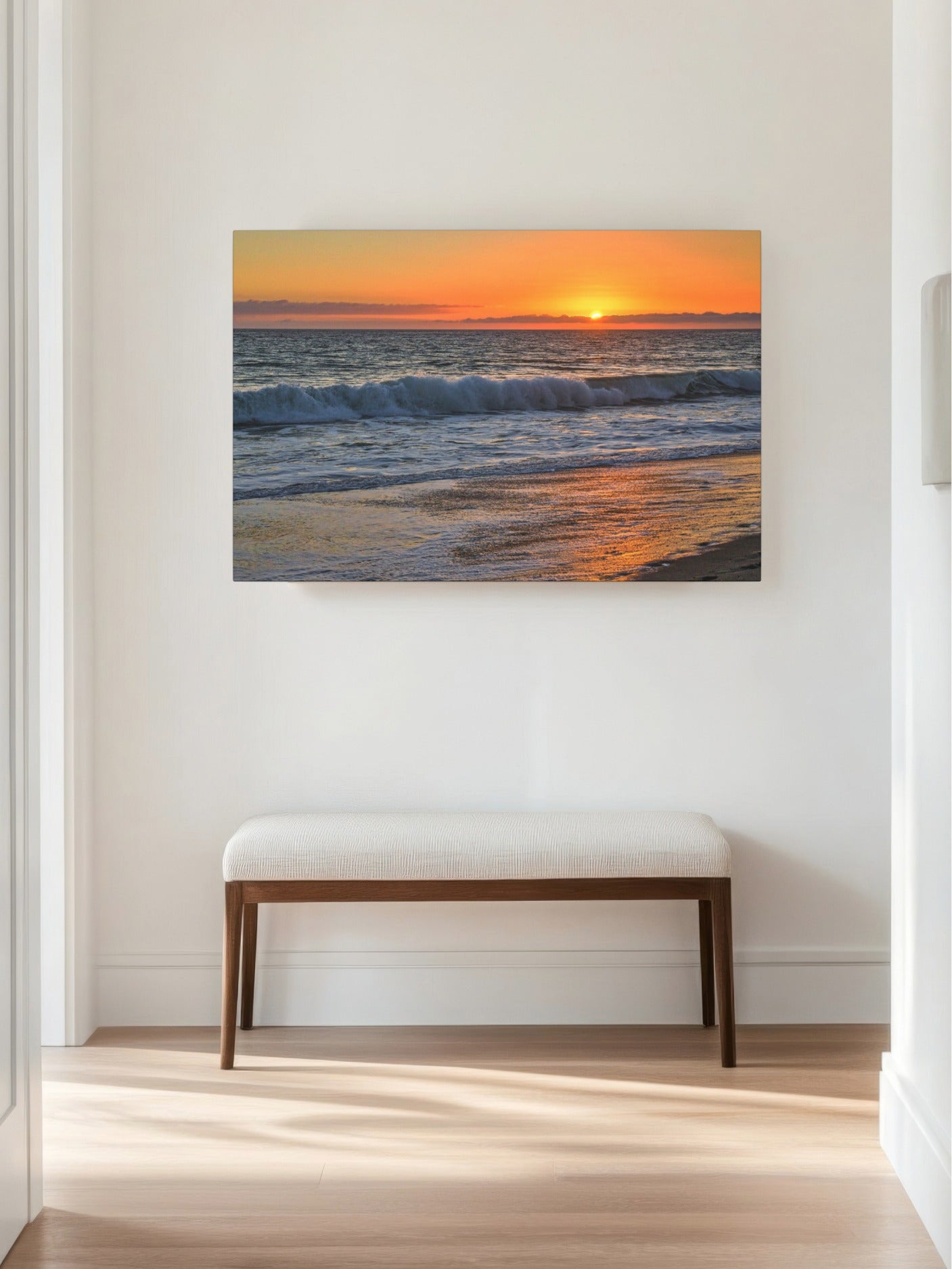 Canvas print of a Zuma Beach sunset in Malibu California with golden sky and reflective sand on a wall above a bench in a room