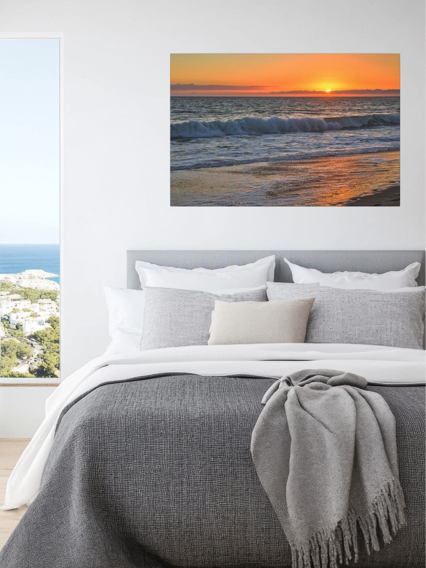 Bedroom with a canvas print of a Zuma Beach sunset in Malibu California with golden sky and reflective sand on the wall.