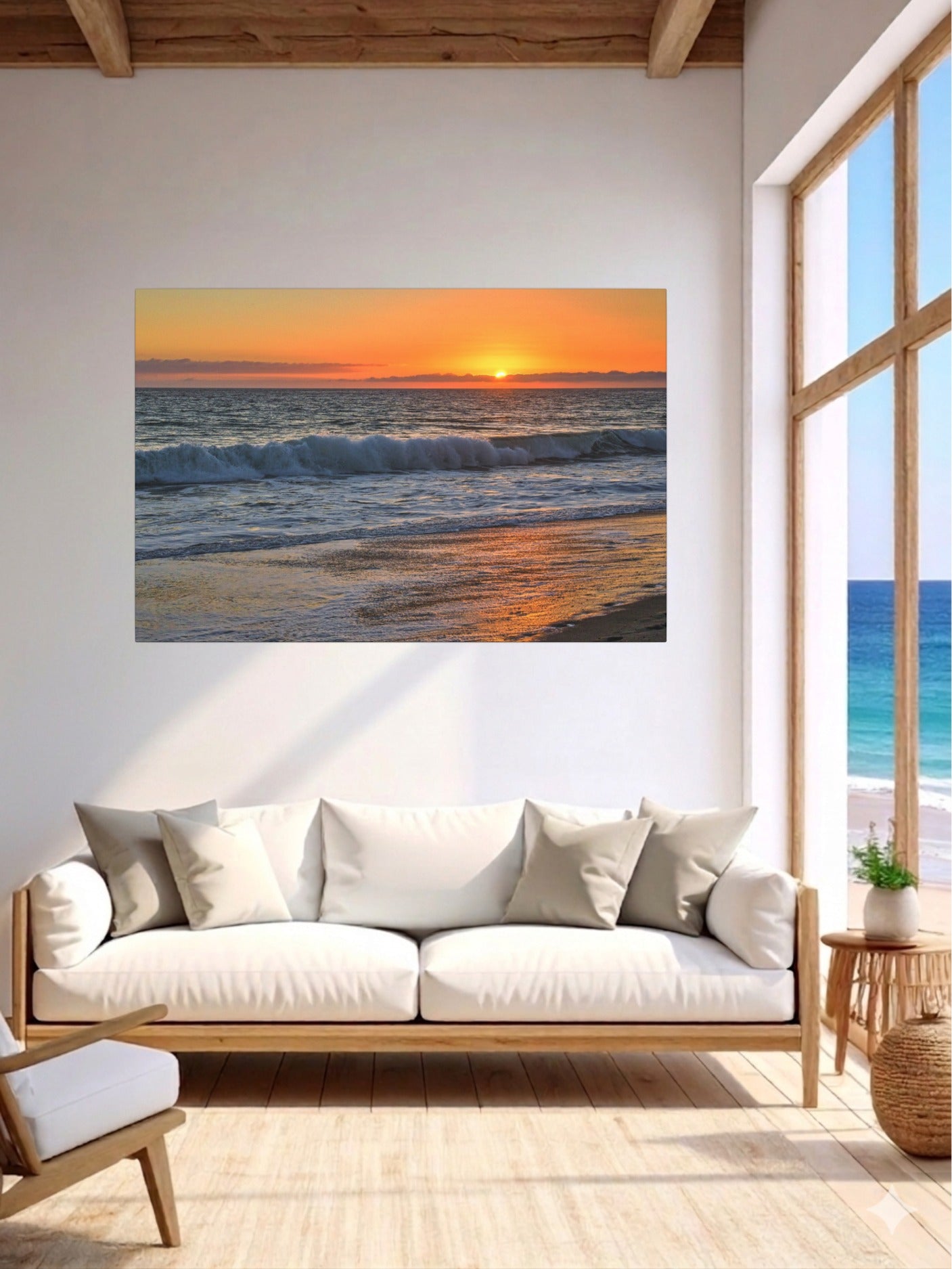 Living room with a large window and a canvas print of a Zuma Beach sunset in Malibu California with golden sky and reflective sand on the wall.